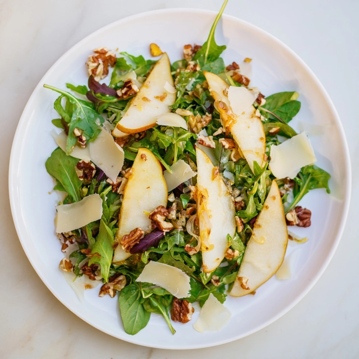 Ensalada de otoño con pera y manchego: una mezcla colorida con aderezo dulce y salado.