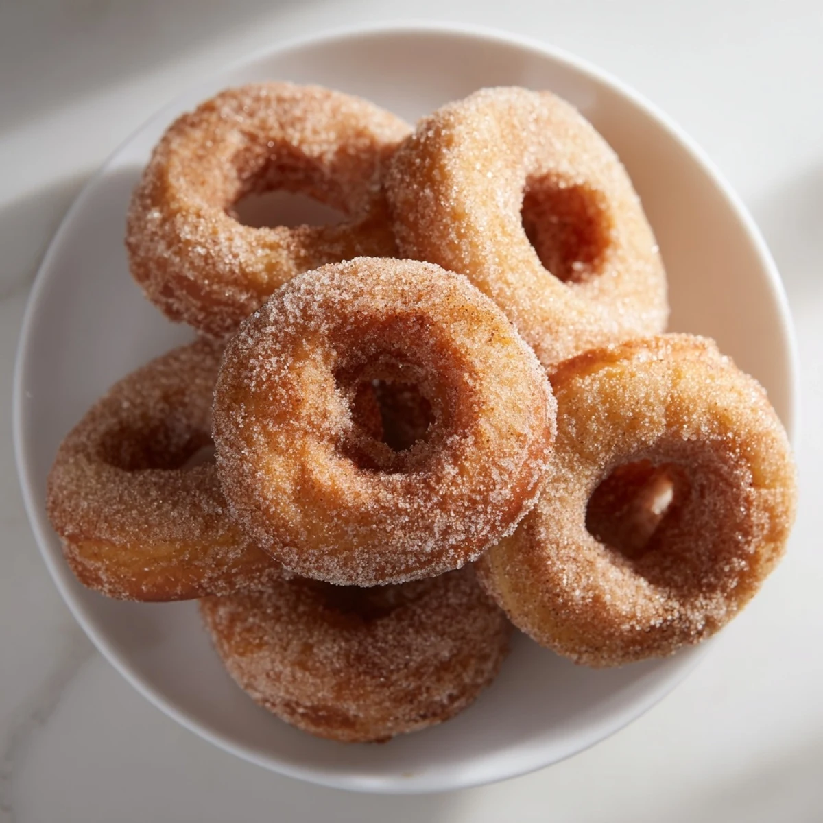 Deliciosas Rosquillas de Canela, doradas y esponjosas, ideales con café en la tarde.  