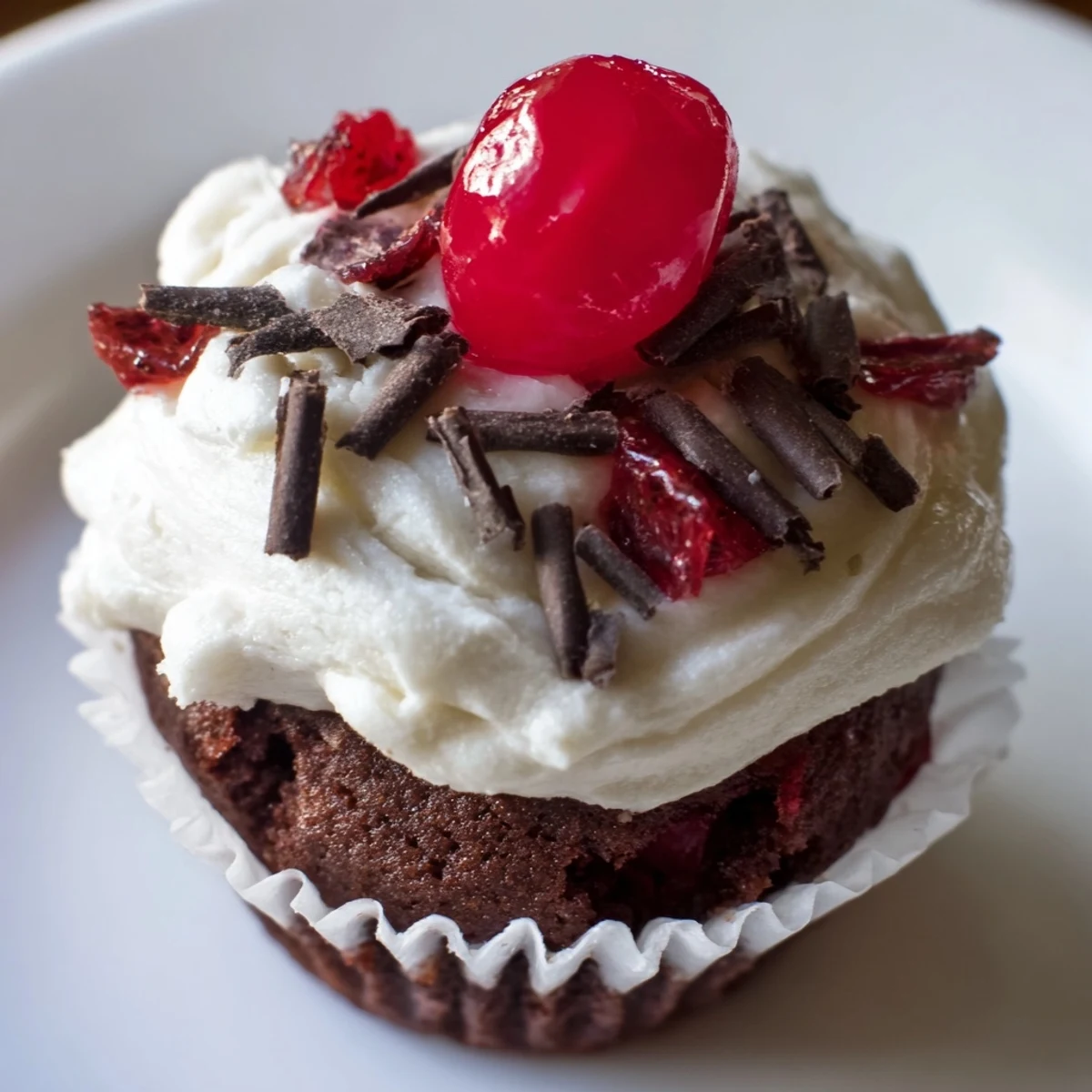 Moist Rocky Cherry Mini Cupcakes with Aged Cream, with glistening cherry halves on top.