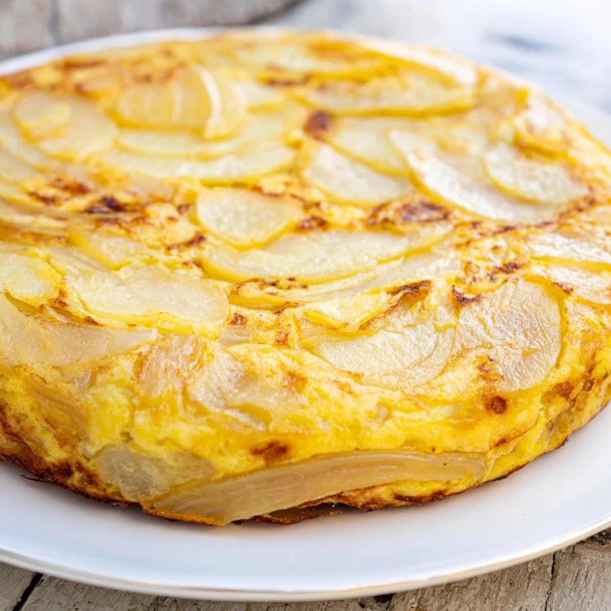 Close-up of a flavorful Simplified Tortilla de Patatas, perfect for a vegetarian tapas or main dish.