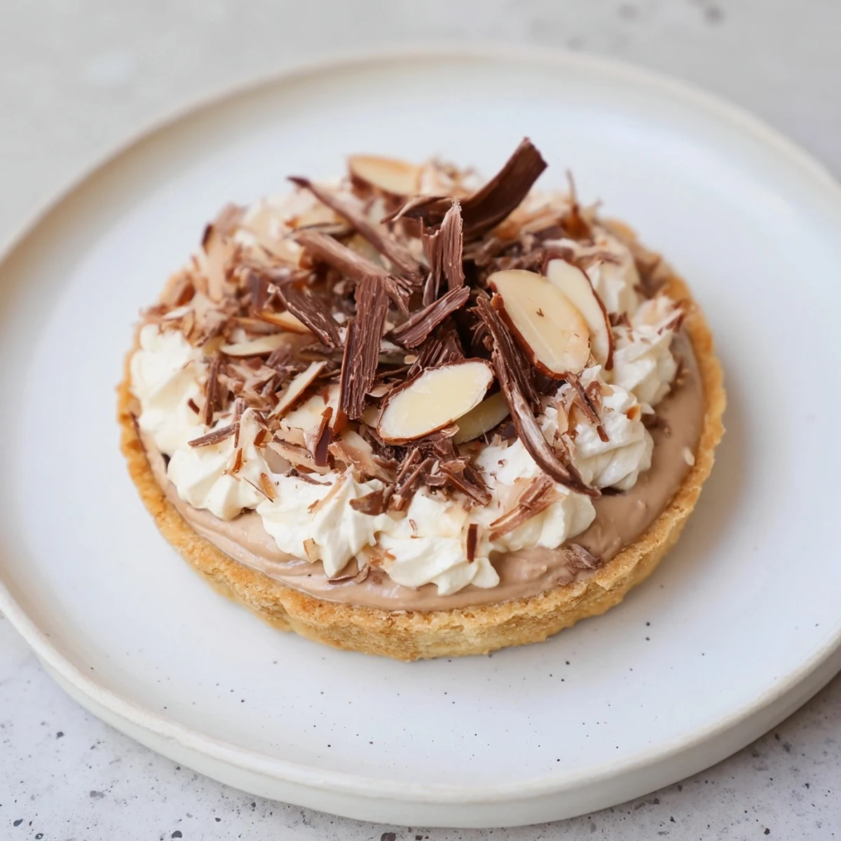 Express Turrón Mousse Tartlets: Delicate, creamy turrón mousse filling mini tartlets topped with toasted almonds.