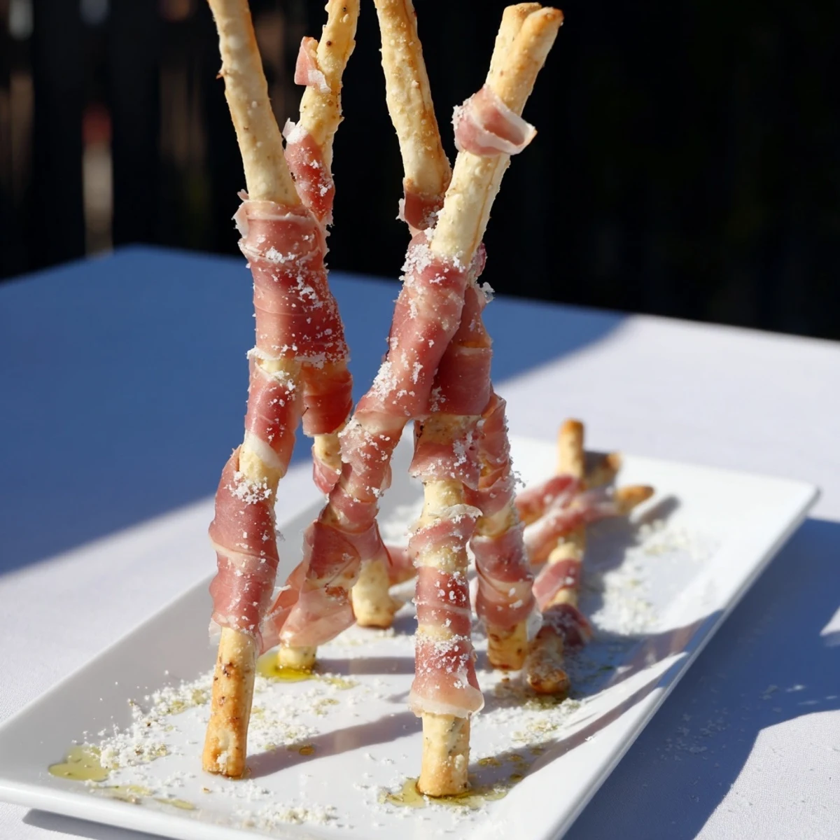 Savory Golden Gate appetizer, featuring prosciutto "bridges" between crispy breadstick structures, ready to eat.