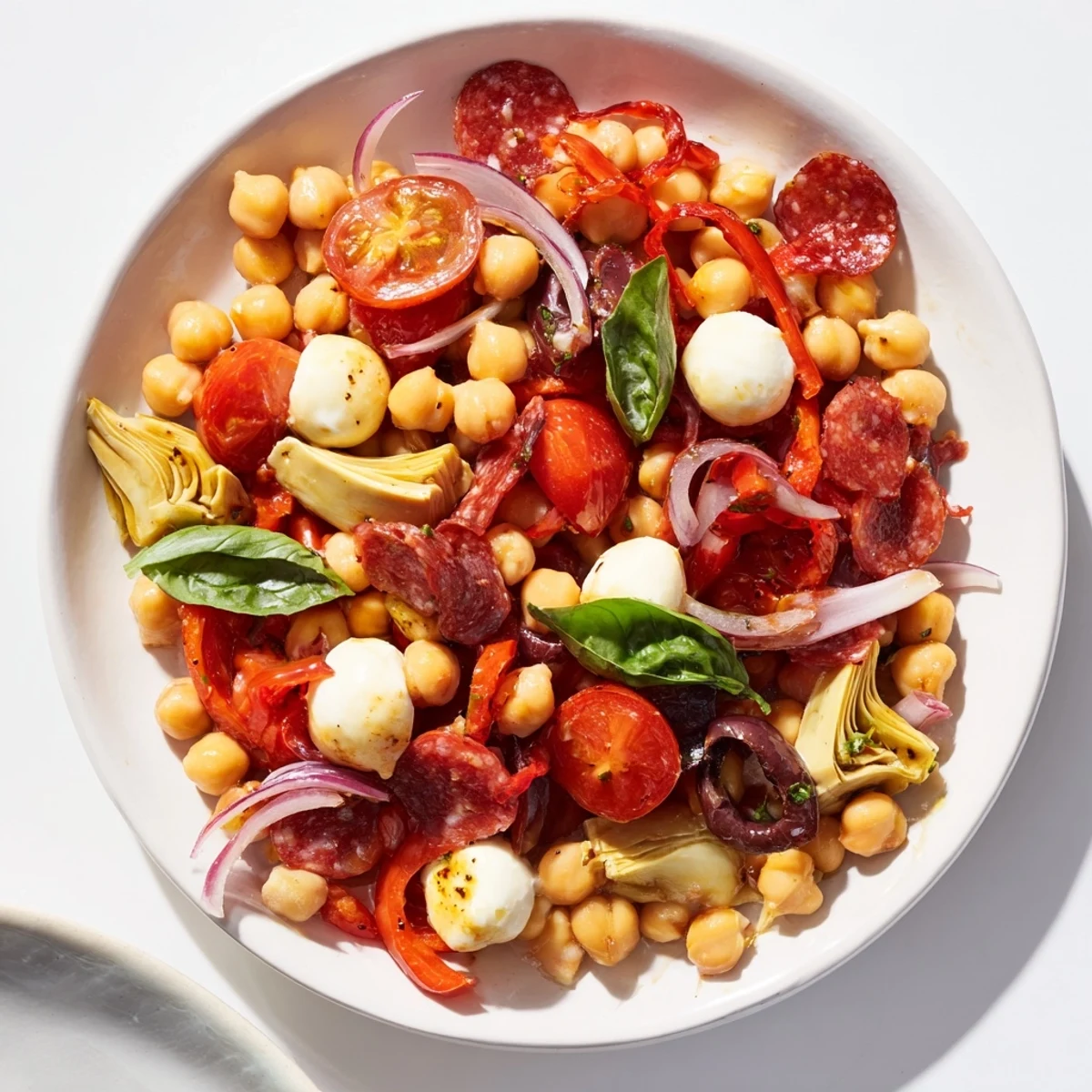 Hearty Antipasto Chickpea Salad with mozzarella, pepperoni, and fresh basil, a flavorful Italian-American salad.