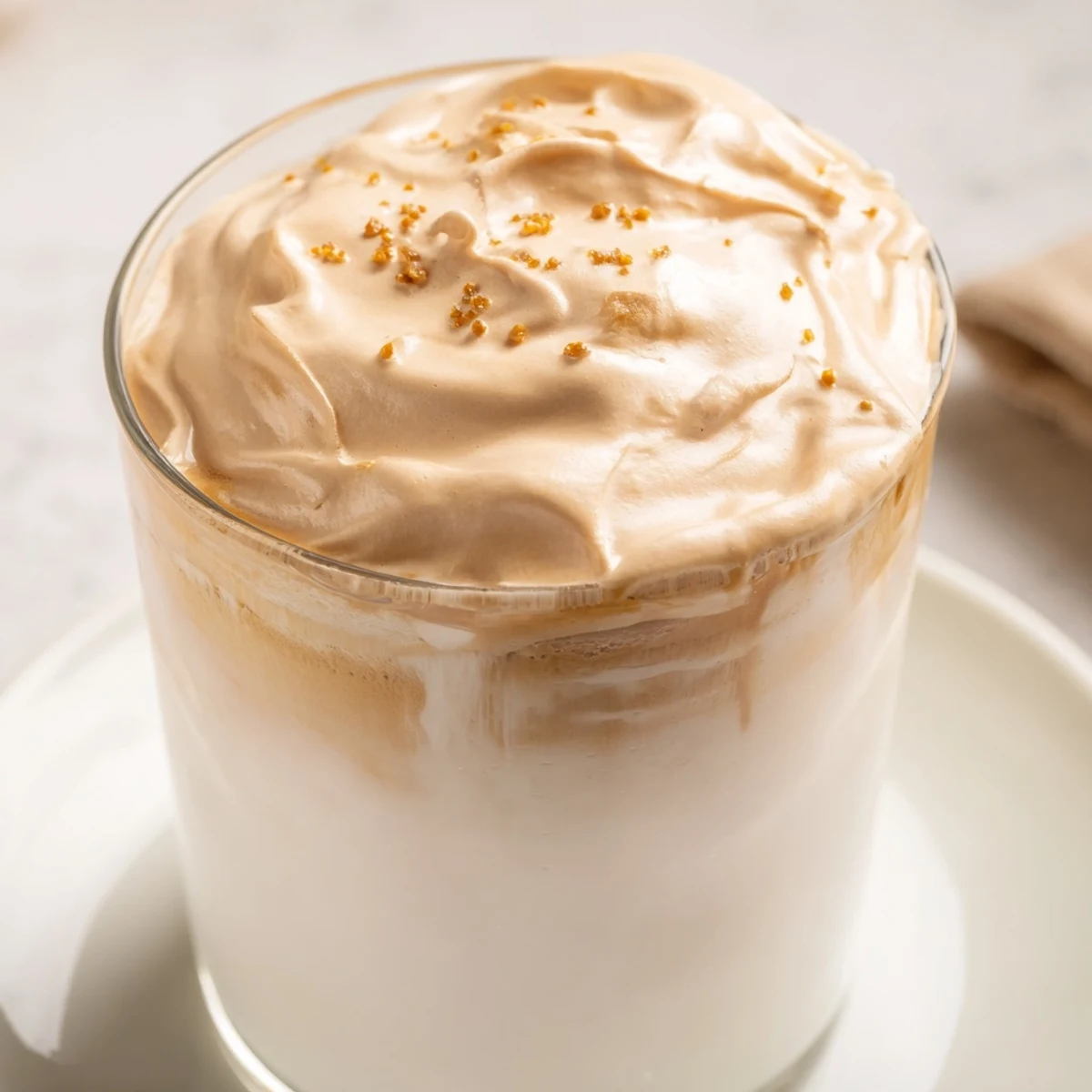 Enjoy a delightful sip of this easy Whipped Dalgona Coffee, ready in minutes with milk and ice.