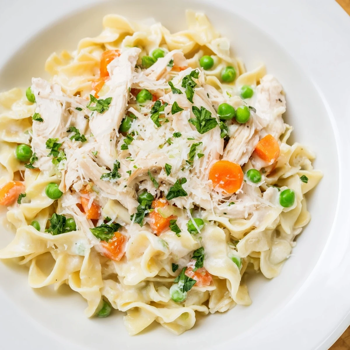 Close-up of a warm bowl of Spring Chicken Noodle Skillet garnished with fresh parsley.