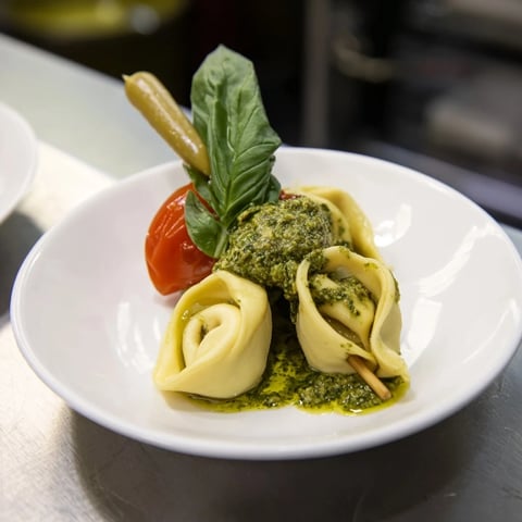 Appetizer Skewers: Tortellini, pesto, and olive skewers, a colorful appetizer arranged on a platter.