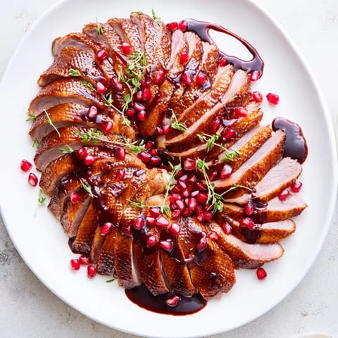Tender roasted duck breast, cooked to perfection, elegantly drizzled with pomegranate sauce.