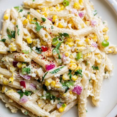 Close-up of Mexican Street Corn Pasta, showing the creamy dressing and vibrant corn kernels.