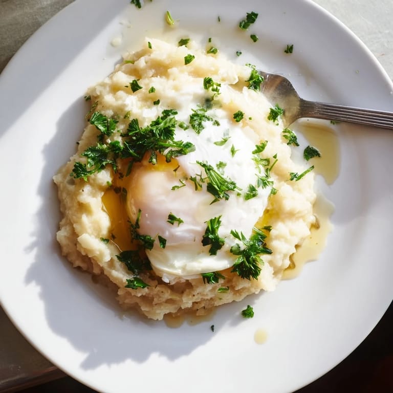 Hearty root vegetable mash with a vibrant poached egg and fresh herbs, ready to serve.