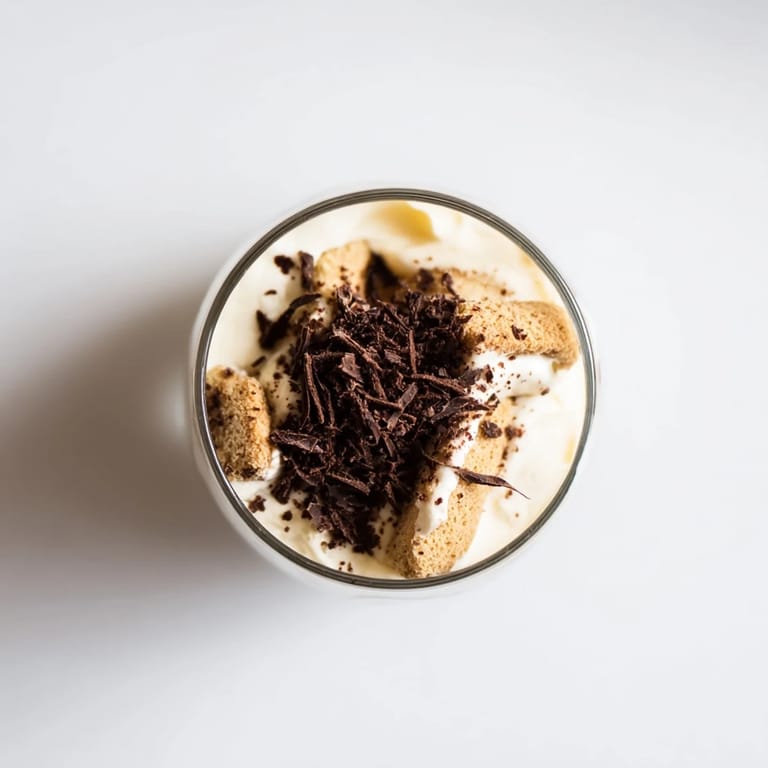 A close-up of delicious Deconstructed Tiramisu Shots, dusted with cocoa powder and ready to enjoy.