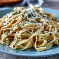 Truffle-Infused Egg Pasta al dente tossed in silky butter, finished with Parmesan and an aromatic drizzle of truffle oil.
